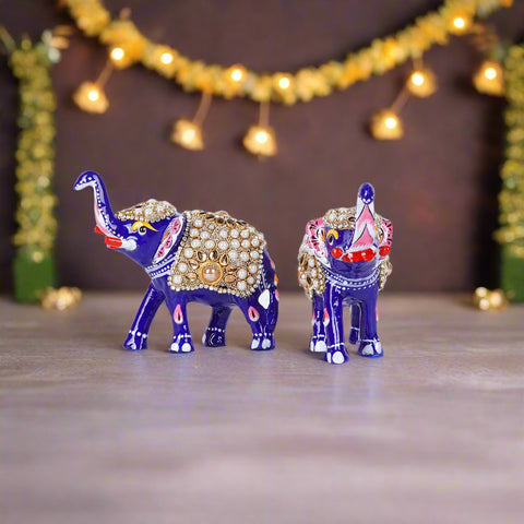 Decorative elephant figurines with jewelry on a white background